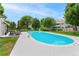 Outdoor pool with lounge chairs surrounded by lush greenery at 1160 S Monaco Pkwy # 6, Denver, CO 80224