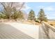 Wide angle view of a back deck with decorative railings, offering access to the yard and surrounding landscape at 14850 Akron St, Brighton, CO 80602