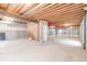 Unfinished basement with exposed ceiling beams, ready for customization to suit your needs at 14850 Akron St, Brighton, CO 80602