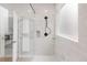 Bright bathroom with marble tiled shower and glass enclosure, adding a touch of luxury at 14850 Akron St, Brighton, CO 80602