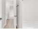 Bright bathroom featuring a shower/tub combo and access to a well lit hallway and sink area at 14850 Akron St, Brighton, CO 80602
