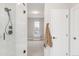 Bathroom featuring a glass-enclosed shower with light tile and an adjoining room, creating an open feel at 14850 Akron St, Brighton, CO 80602