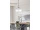 Close-up of a modern chandelier and stylish dining table decor in a brightly lit space at 14850 Akron St, Brighton, CO 80602