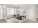 Inviting dining space bathed in natural light, enhanced by a modern chandelier and refined decor at 14850 Akron St, Brighton, CO 80602