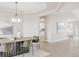 The dining room features natural light, flowing into an open space with modern decor and chandelier at 14850 Akron St, Brighton, CO 80602
