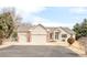 Charming single-story home with a three-car garage and well-maintained landscaping at 14850 Akron St, Brighton, CO 80602