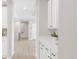 Bright hallway featuring hardwood floors and elegant white trim at 14850 Akron St, Brighton, CO 80602
