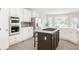 Spacious kitchen features a center island, stainless appliances, and lots of natural light at 14850 Akron St, Brighton, CO 80602