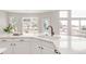 White kitchen with a breakfast bar and a view of the backyard at 14850 Akron St, Brighton, CO 80602