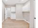 Spacious laundry room with a sink and ample white cabinet storage, perfect for all your laundry needs at 14850 Akron St, Brighton, CO 80602