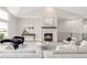 Bright living room features a stone fireplace, high ceilings, and modern decor for a luxurious feel at 14850 Akron St, Brighton, CO 80602