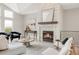 Cozy living room with a stone fireplace, stylish decor, and ample natural light at 14850 Akron St, Brighton, CO 80602