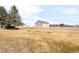 A large lot with a 2 car detached building in the distance at 14850 Akron St, Brighton, CO 80602