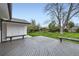 Large deck with built in benches overlooking landscaped backyard and mature trees at 10020 Bryant St, Denver, CO 80260