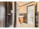 Bathroom featuring dark tile, shower, and classic fixtures at 10020 Bryant St, Denver, CO 80260
