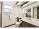 Bright bathroom with a shower, vanity, and large mirror at 10020 Bryant St, Denver, CO 80260