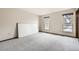 Well-lit bedroom with plush carpet and two windows offering outdoor views at 10020 Bryant St, Denver, CO 80260