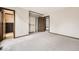 Neutral bedroom featuring an open closet, carpet, and fresh wall paint at 10020 Bryant St, Denver, CO 80260