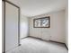 Cozy bedroom with a closet and window offering a view of nearby trees at 10020 Bryant St, Denver, CO 80260