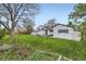 Exterior view of home with deck and spacious yard with large mature trees at 10020 Bryant St, Denver, CO 80260