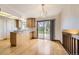 Bright kitchen featuring natural wood cabinets, sliding glass doors, and a view of the backyard at 10020 Bryant St, Denver, CO 80260