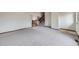 Spacious living area with neutral carpet, leading to an open staircase and a welcoming entrance at 10020 Bryant St, Denver, CO 80260