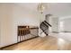 Bright living area featuring hardwood floors, staircase, and stylish chandelier lighting at 10020 Bryant St, Denver, CO 80260