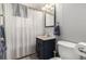 Functional bathroom featuring a vanity with storage, a mirrored cabinet, and a shower with a curtain at 2612 Meadowbrook Dr, Denver, CO 80221