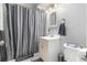 Bathroom features a shower with curtain and a modern vanity with sink at 2612 Meadowbrook Dr, Denver, CO 80221