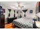 Comfortable bedroom with hardwood floors, a ceiling fan, and soft natural light from the window at 2612 Meadowbrook Dr, Denver, CO 80221