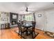Bright dining area with hardwood floors, a brick fireplace, and large windows offering ample natural light at 2612 Meadowbrook Dr, Denver, CO 80221