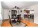 Charming dining area featuring hardwood floors, a china cabinet, and an open view to the modern kitchen at 2612 Meadowbrook Dr, Denver, CO 80221