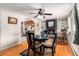 Cozy dining room featuring a black brick fireplace, hardwood floors, and an open view to the kitchen at 2612 Meadowbrook Dr, Denver, CO 80221