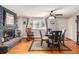 Warm dining room with a brick fireplace, hardwood floors, and a rocking chair, exuding comfort and style at 2612 Meadowbrook Dr, Denver, CO 80221