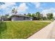 Charming home featuring a well-manicured lawn, gray exterior, and inviting curb appeal at 2612 Meadowbrook Dr, Denver, CO 80221