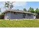 Charming single-story home with a well-maintained lawn, featuring a gray brick facade and cozy curb appeal at 2612 Meadowbrook Dr, Denver, CO 80221
