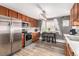 View of updated kitchen featuring stainless steel appliances and eat in dining area with natural light at 2612 Meadowbrook Dr, Denver, CO 80221