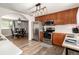 View of updated kitchen featuring stainless steel appliances and eat in dining area at 2612 Meadowbrook Dr, Denver, CO 80221