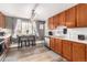 View of updated kitchen featuring stainless steel appliances and eat in dining area with natural light at 2612 Meadowbrook Dr, Denver, CO 80221