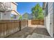 Narrow backyard with wood fencing, small gravel area, and clear sky at 1145 S Boston St, Denver, CO 80247