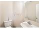 Clean half bathroom with a single sink and white walls at 1145 S Boston St, Denver, CO 80247
