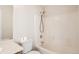 Bright bathroom featuring a shower-tub, toilet, and sink with counter and white tile at 1145 S Boston St, Denver, CO 80247