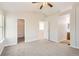 Bright bedroom with carpet, ceiling fan, and access to a walk-in closet and bathroom at 1145 S Boston St, Denver, CO 80247