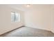 Clean bedroom with neutral color scheme and carpet flooring, plus window with bright light at 1145 S Boston St, Denver, CO 80247