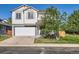 Charming two-story home with a well-maintained lawn and attached two-car garage at 1145 S Boston St, Denver, CO 80247