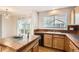 Kitchen area featuring an island, wood cabinets, and sliding glass door at 1145 S Boston St, Denver, CO 80247