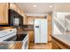 Kitchen boasts updated appliances, wood cabinets, and tile countertops at 1145 S Boston St, Denver, CO 80247