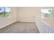 Upper level carpeted landing space with neutral paint and natural light streaming in from the windows at 1145 S Boston St, Denver, CO 80247