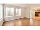 Open-concept living room featuring hardwood floors and access to the kitchen at 1145 S Boston St, Denver, CO 80247