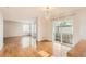 Bright living room with hardwood floors, chandelier, and sliding glass door at 1145 S Boston St, Denver, CO 80247